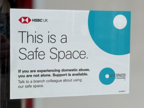 Photo of a sign with the HSBC logo that reads 'this is a safe space' and directions on how to access safe spaces.