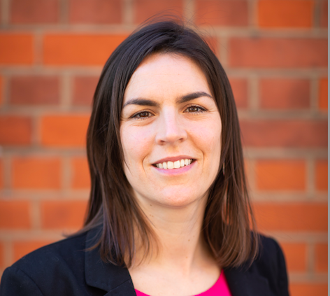 photo of person with brown hair looking at the camera