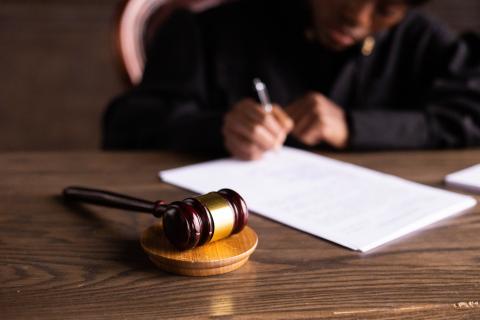 a person in court writing on white paper