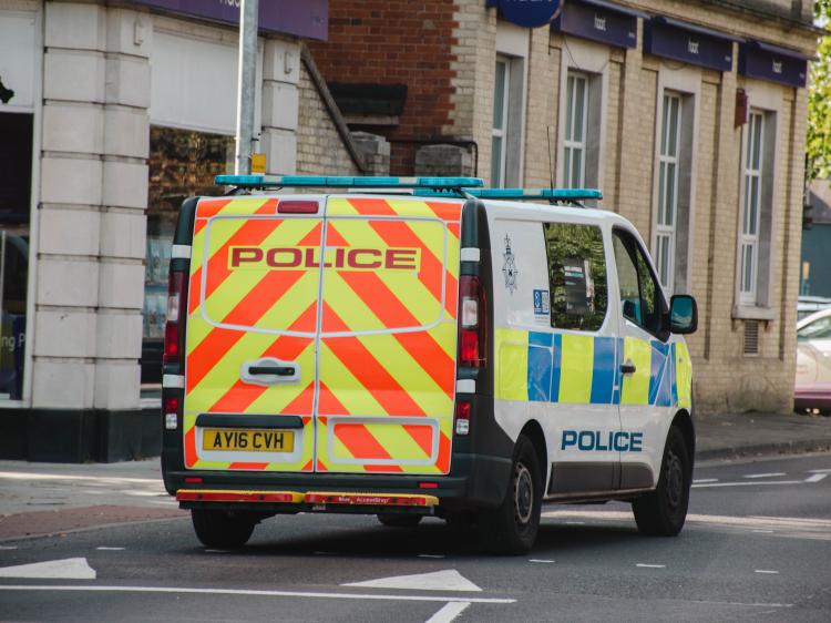 a police van drives through the street